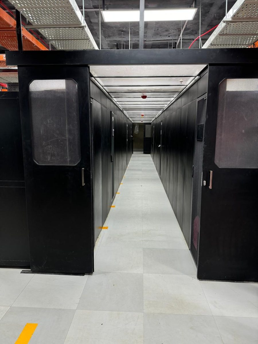 Contained aisle of server racks in a data centre